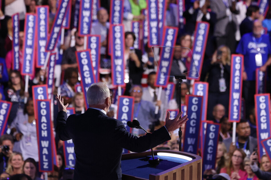 Minnesota Governor Tim Walz speaks as supporters raise "Coach Walz" during his address at the Democratic National Convention in Chicago, Illinois.