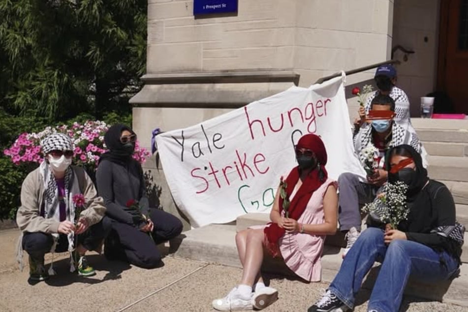 Hunger strikers and supporters sit outside Sheffield-Sterling-Strathcona Hall as they demand Yale administrators take action to end the university's complicity in the atrocities in Palestine.