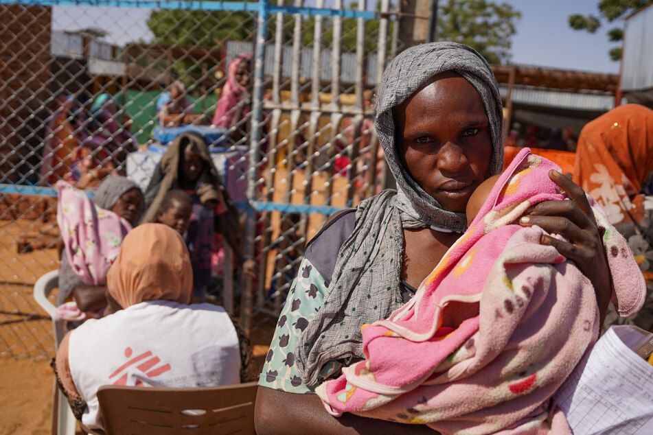 A woman and baby are pictured at the Zamzam displacement camp, close to El Fasher in North Darfur, Sudan.