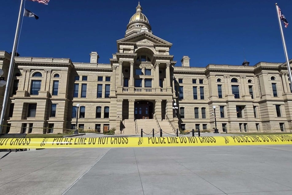 Police tape is pictured in front of the Wyoming State Capitol on October 21, 2025, amid an investigation into a suspected explosive device found on the grounds.