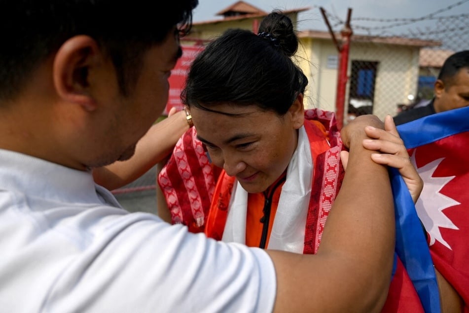 Phunjo Jhangmu Lama is greeted by the crowd upon her arrival at the Tribhuvan International airport in Kathmandu.