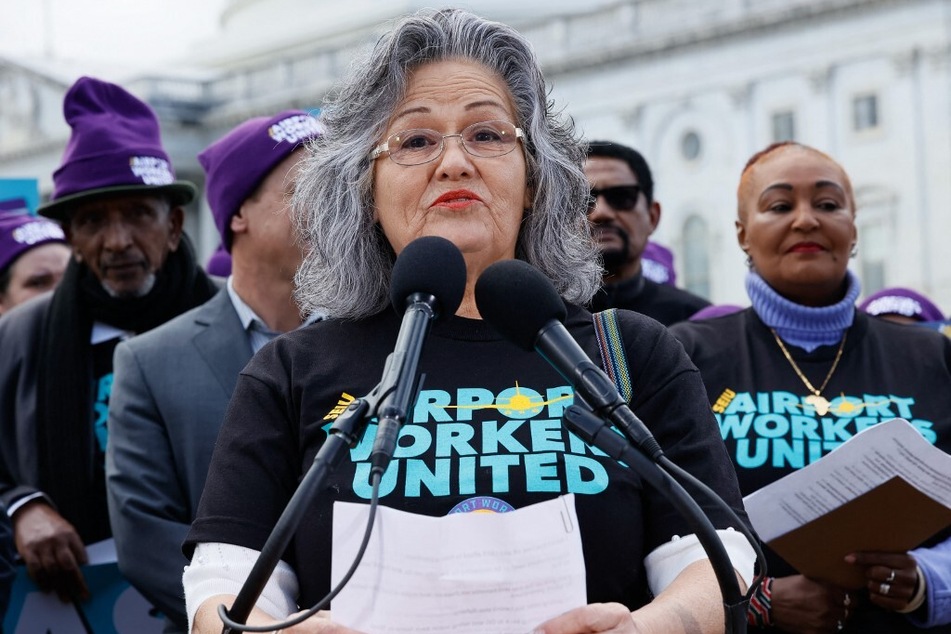 Verna Montalvo, a Dallas-Fort Worth-based cabin cleaner, speaks during a press conference held by airport workers and members of the Service Employees International Union.