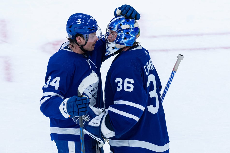 Toronto Maple Leafs Center Auston Matthews (34) congratulates Toronto Maple Leafs Goalie Jack Campbell (36) after their 3-2 win over Montreal.