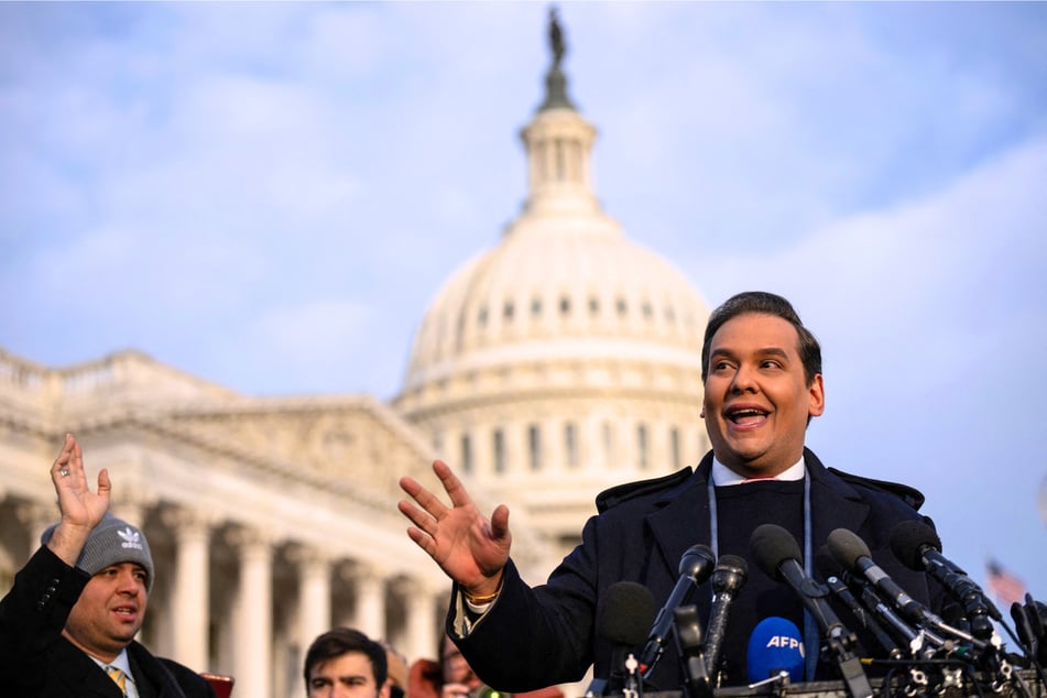 In a recent interview, George Santos (pictured) compared Donald Trump commuting his prison sentence to the president pardoning Jesus Christ.