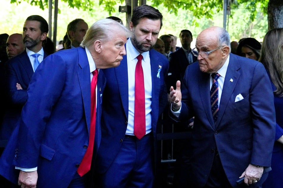 President Donald Trump (l.) speaks with Vice President JD Vance (c.) and Rudy Giuliani during a remembrance ceremony on the 23rd anniversary of the 9/11 terror attack in New York City on September 11, 2024.
