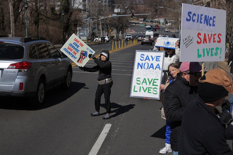 Demonstrators protest against Department of Government Efficiency cuts outside the headquarters of the National Oceanic and Atmospheric Administration in Silver Spring, Maryland.