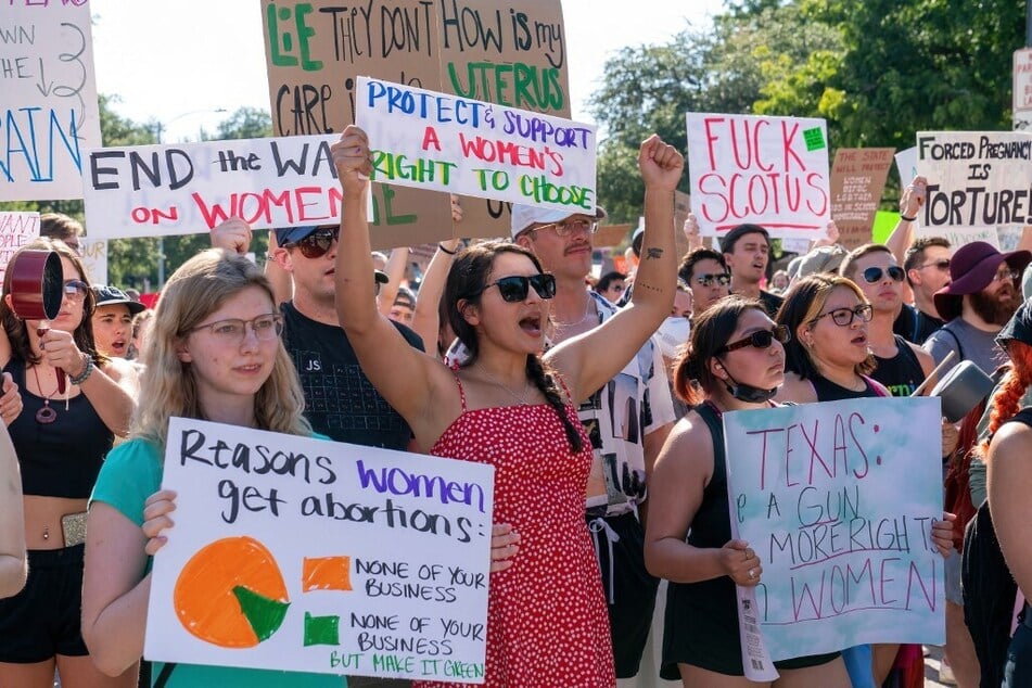 Abortion rights demonstrators hold signs as they gather near the State Capitol in Austin, Texas, after the US Supreme Court decided to overturn Roe v. Wade.