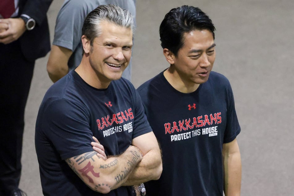 US Secretary of Defense Pete Hegseth (l.) stands next to Japanese Defense Minister Shinjiro Koizumi as they prepare to train with soldiers from the US Army's 3rd Infantry Regiment (The Old Guard) at Joint Base Myer-Henderson Hall in Arlington, Virginia, on January 15, 2026.