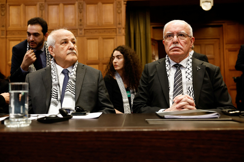 Palestinian Foreign Minister Riyad al-Maliki and Palestinian UN envoy Riyad Mansour attend a public hearing held by the International Court of Justice on the legal consequences of Israeli occupation.