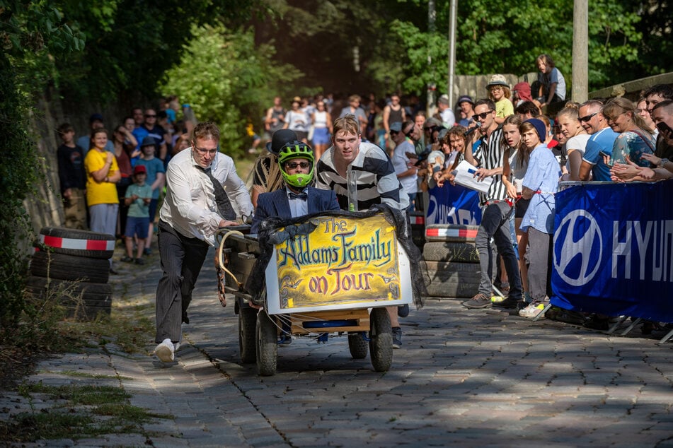 Die Crew von "Addam's Family" schob eine Art mobilen Sarg Richtung Ziel.