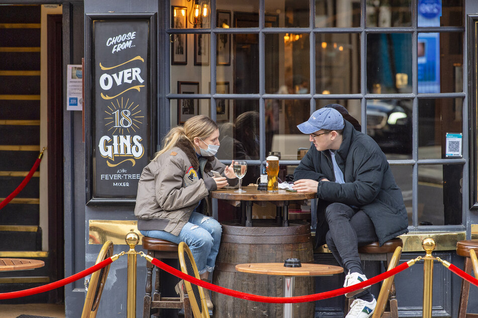 Rauchfrei geht es auch: Gäste sitzen vor einem Pub.
