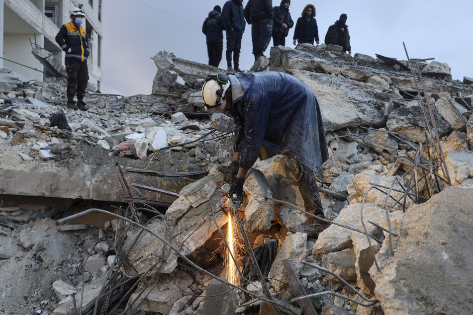 The White Helmets look for casualties under the rubble in the town of Zardana, northwestern Syrian Idlib province.