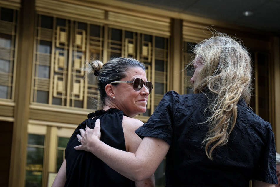 Sexual assault survivors embrace following the sentencing of former gynecologist Robert Hadden.