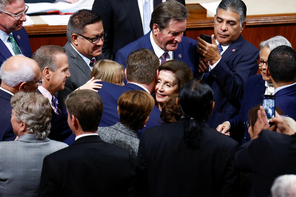 House Democrats gather around Pelosi after her speech.