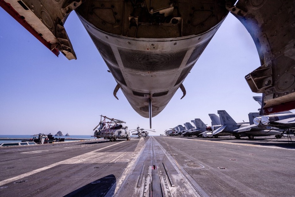 F/A-18 jets are seen on the flight deck aboard the USS Nimitz aircraft carrier, which is taking part in joint military exercises with South Korea and Japan.