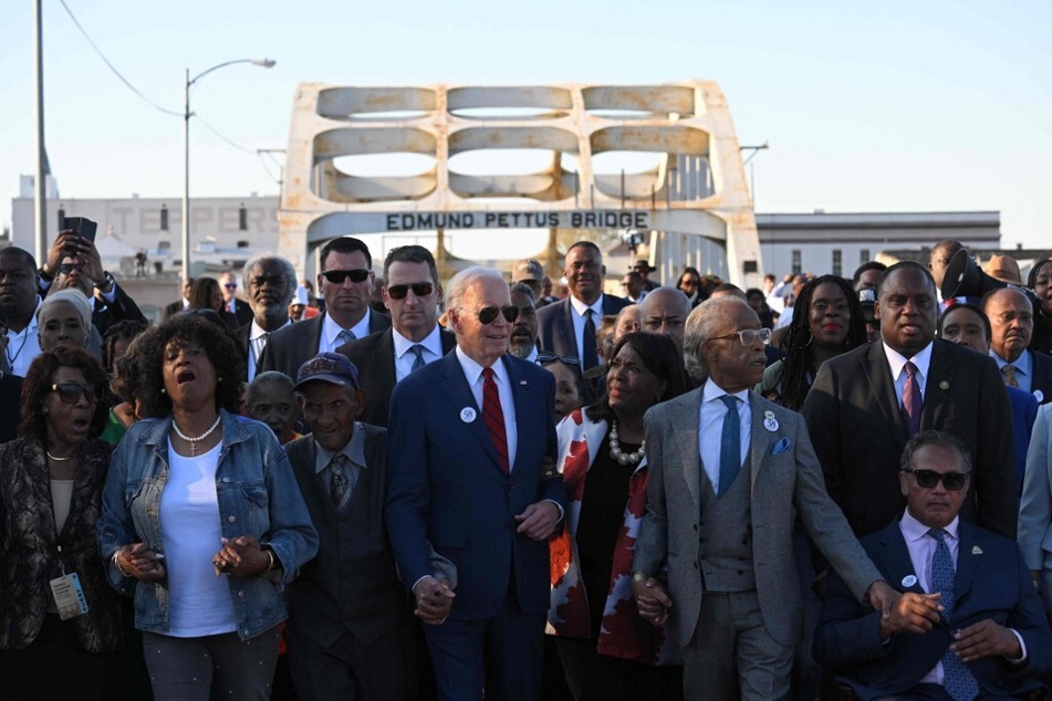 President Joe Biden, joined by US Representative Terri Sewell, Reverend Al Sharpton, Reverend Jesse Jackson, Martin Luther King III, and fellow activists cross the Edmund Pettus Bridge in Selma, Alabama, on March 5, 2023, to mark the 58th anniversary of Bloody Sunday.