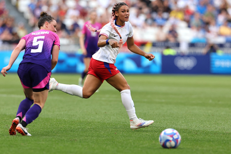 Trinity Rodman of the USA in action with Marina Hegering of Germany during the women's soccer semi-final at the Paris Olympics.