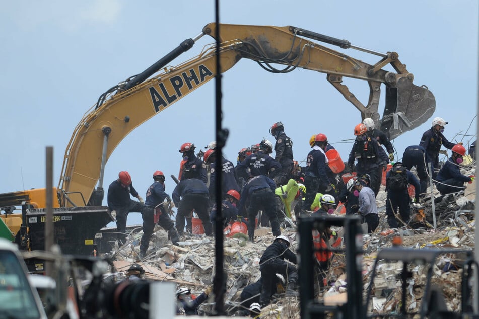 Rescue workers continue to sift through the rubble as the search efforts stretch into their seventh day.