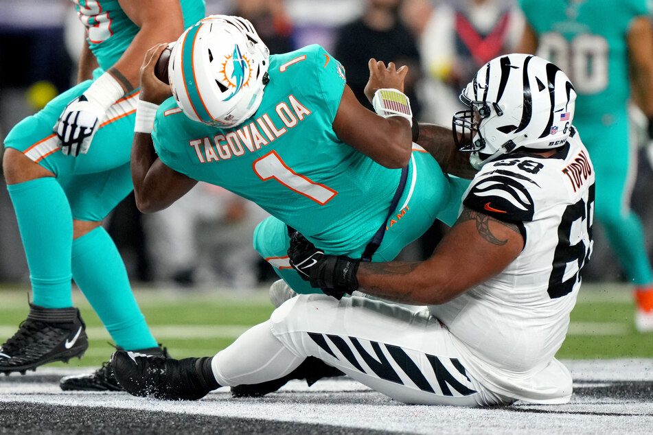 Cincinnati Bengals defensive tackle Josh Tupou sacks Miami Dolphins quarterback Tua Tagovailoa in the second quarter at Paycor Stadium in Cincinnati.