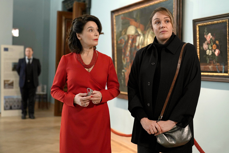 Anna (r.) will bei Museumsleiterin Alexandra von Reuten die Sachen ihres Mannes abholen.
