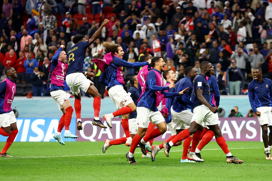 Aurelien Tchouameni, Matteo Guendouzi, William Saliba, and teammates celebrate after the match as France progress to the semi-finals of the 2022 World Cup.