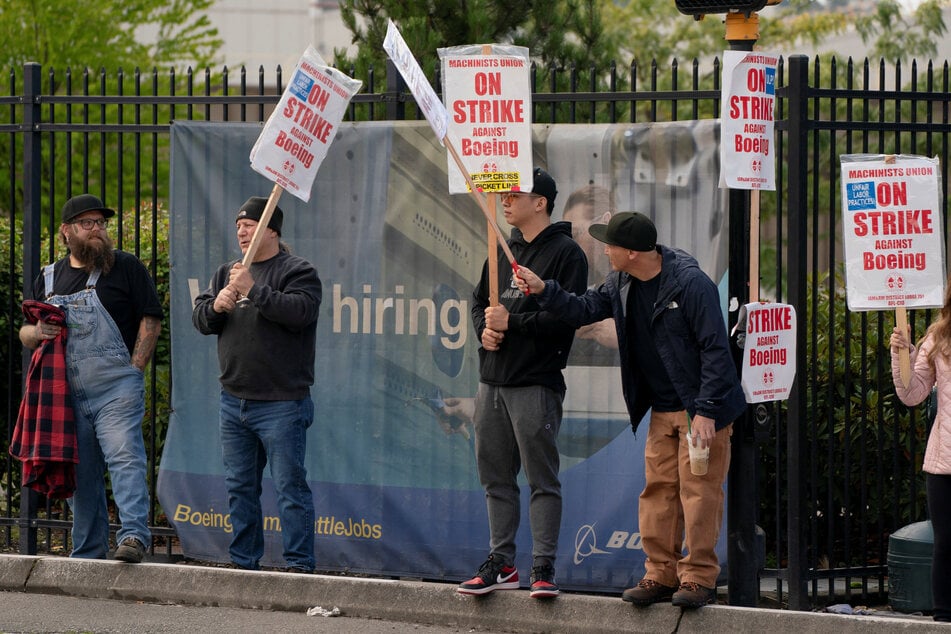 Boeing factory workers and supporters gather on a picket line during a strike near the entrance to a production facility in Renton, Washington.