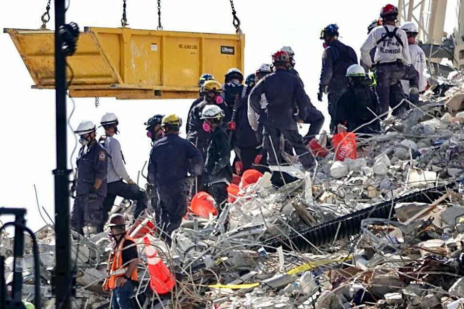 A bucket brigade works to remove debris on Monday.