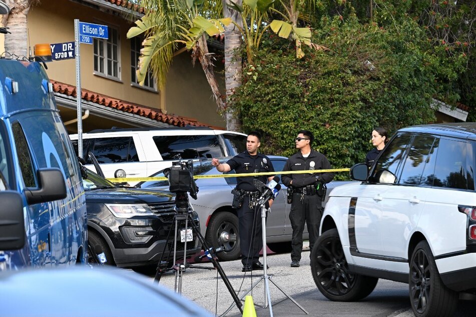 Law enforcement work an investigation after an early morning shooting that left three people dead and four wounded in the Beverly Crest neighborhood of Los Angeles, just north of Beverly Hills.