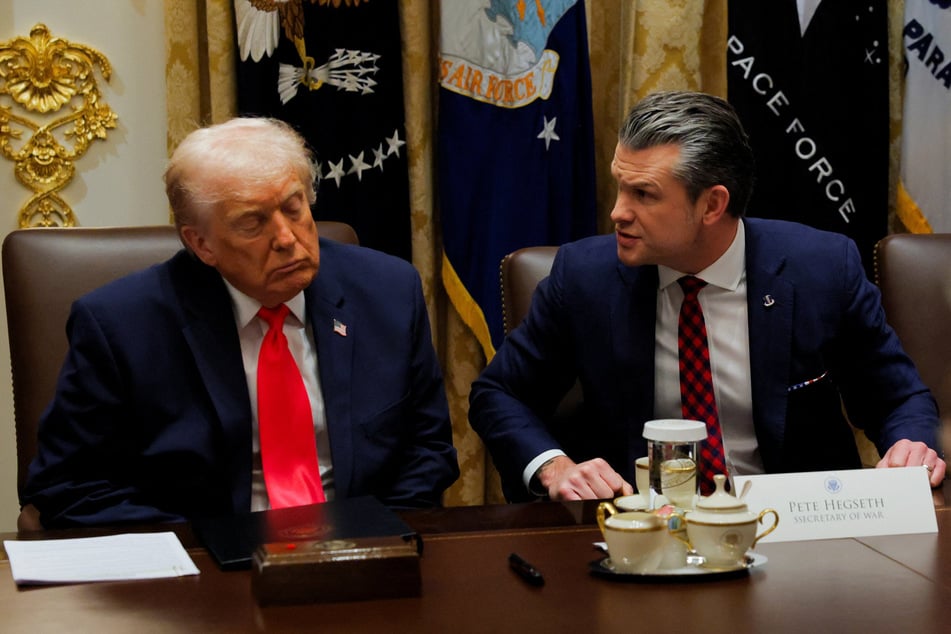 President Donald Trump (l.) has continued to back Hegseth, despite the mounting pressure.