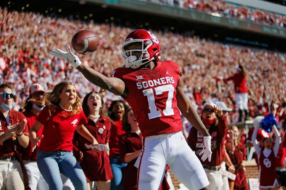 Wide receiver Marvin Mims of the Oklahoma Sooners pops and rolls the ball off his fingertips after scoring on a 67-yard catch and run for a touchdown against the Texas Tech Red Raiders.