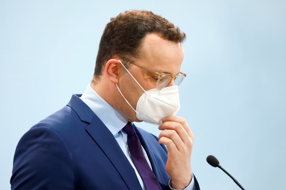Bundesgesundheitsminister Jens Spahn (CDU) setzt seinen Mundschutz auf nach der Pressekonferenz vor dem Start des Impfprogramms gegen die Coronavirus-Erkrankung.