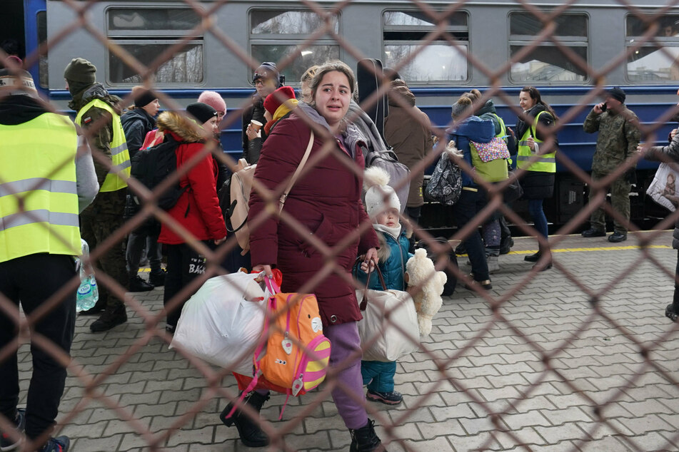 A woman and her child arrive at Przemyśl station in Poland after fleeing Ukraine.