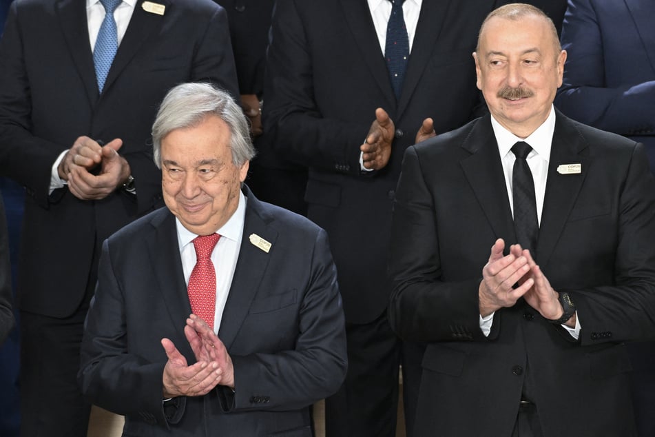 United Nations (UN) Secretary General Antonio Guterres (l.) and Azerbaijan's President Ilham Aliyev (r.) attend a group photo during the United Nations Climate Change Conference (COP29) in Baku on Tuesday.