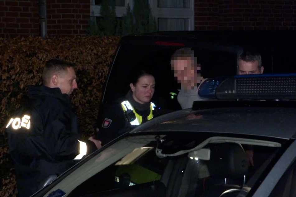 Polizisten nehmen den Mann mit auf dei Wache.