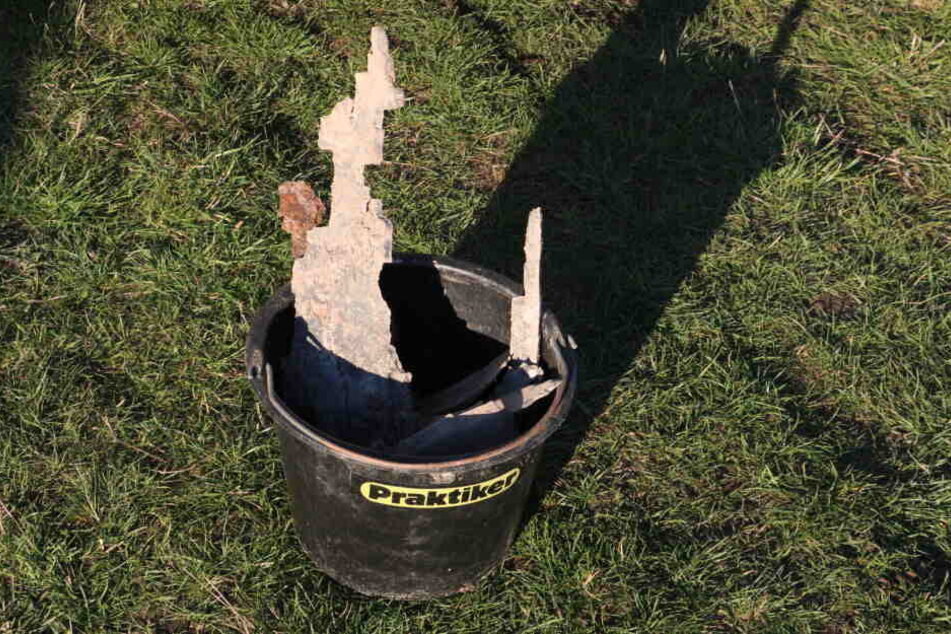 Die verbliebenen Reste der Bombe wurden in einem Eimer eingesammelt.