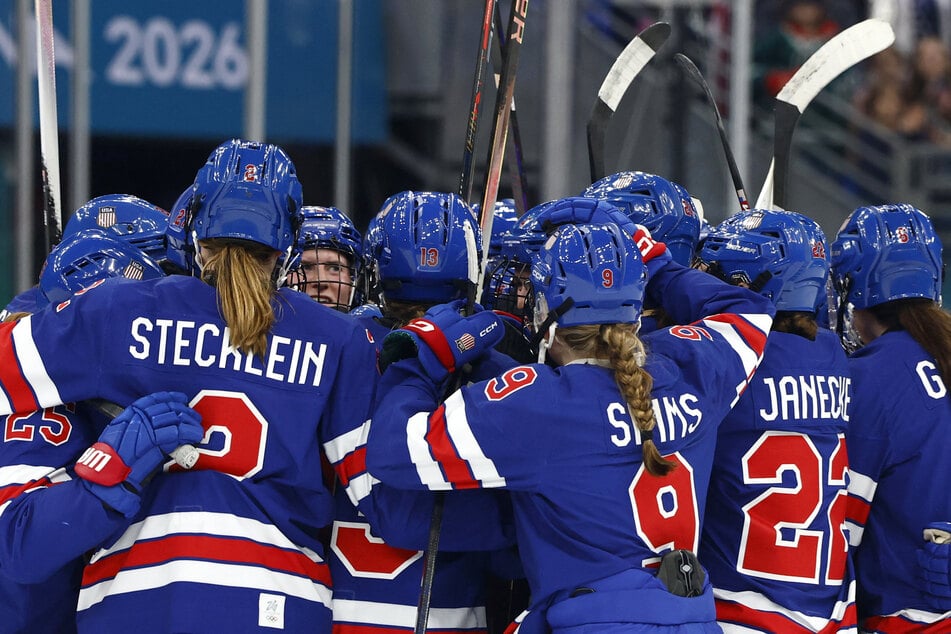 Team USA players celebrate after their women's ice hockey semi-final match against Sweden at the Milan Cortina Olympics on February 16, 2026.