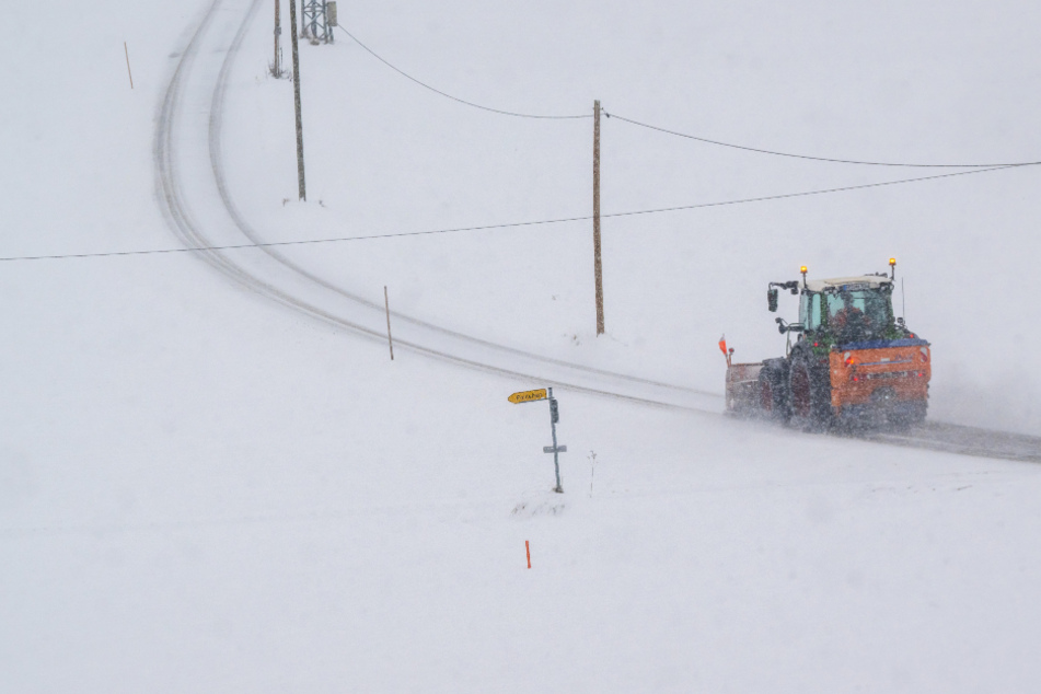 Ein Schneeräumfahrzeug fährt über eine kleine Verbindungsstraße bei Miesbach am Samstag. Vor allem in Alpennähe hat es kräftig geschneit.