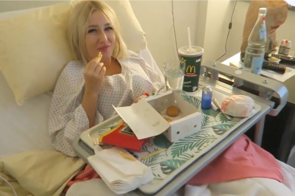 Vom Krankenhausbett aus, berichtet die Blondine über den Eingriff.