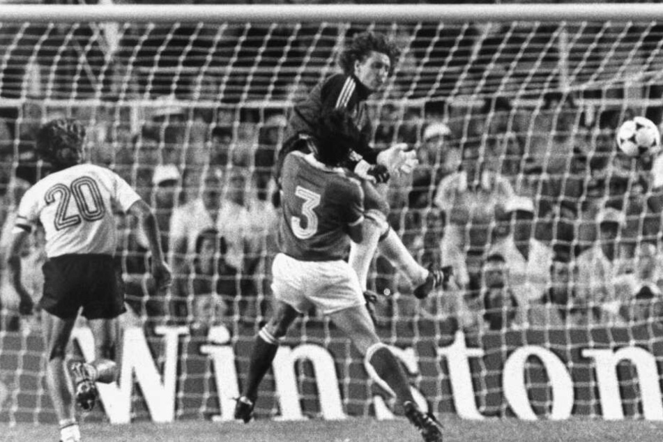 Toni Schumacher springt während des WM-Halfinalspiels 1982 gegen Frankreich aus vollem Lauf den französischen Spieler Patrick Battiston an.