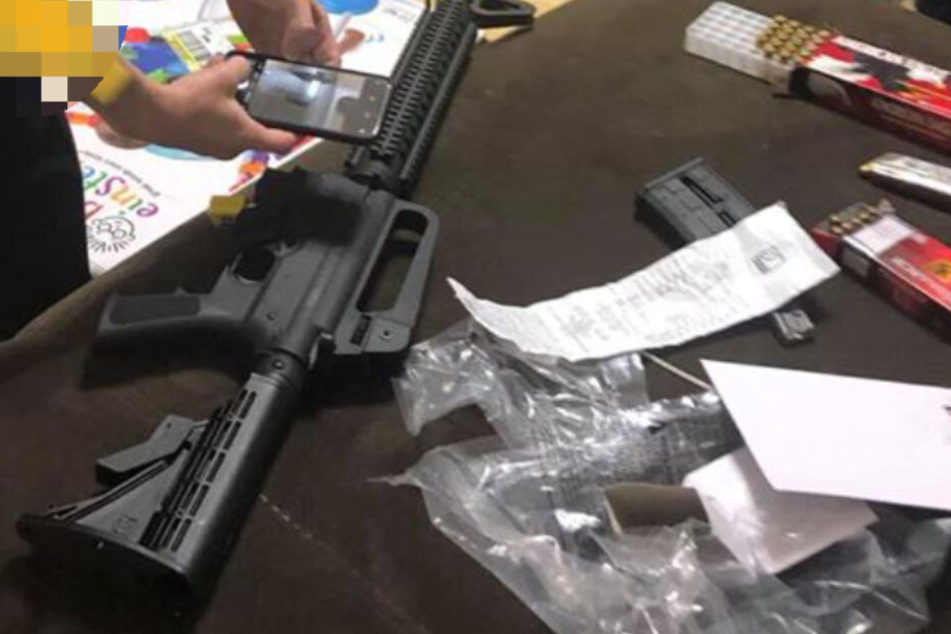 Ein Polizist fotografiert das Gewehr.