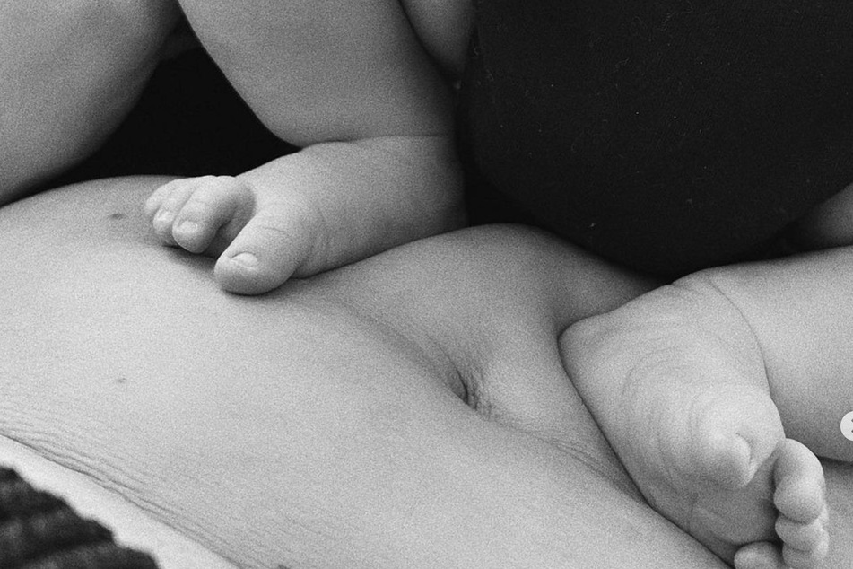 Kylie also shared a black-and-white pic of her newborn son's feet laying on her stomach.