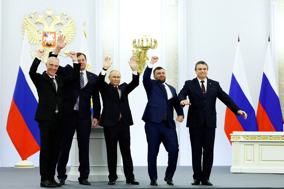 Putin (3rd from l.) celebrates alongside the four pro-Russian leaders of Luhansk, Donetsk, Zaporizhzhia and Kherson.