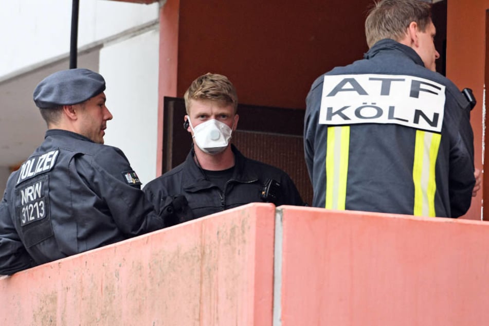 Polizisten und ein Feuerwehrmann der Analytischen Taskforce bei der Wohnungs-Durchsuchung in Köln-Chroweiler Mitte Juni.