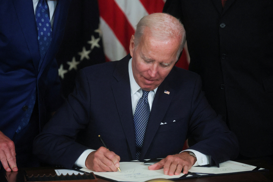 President Joe Biden signs the Inflation Reduction Act into law.