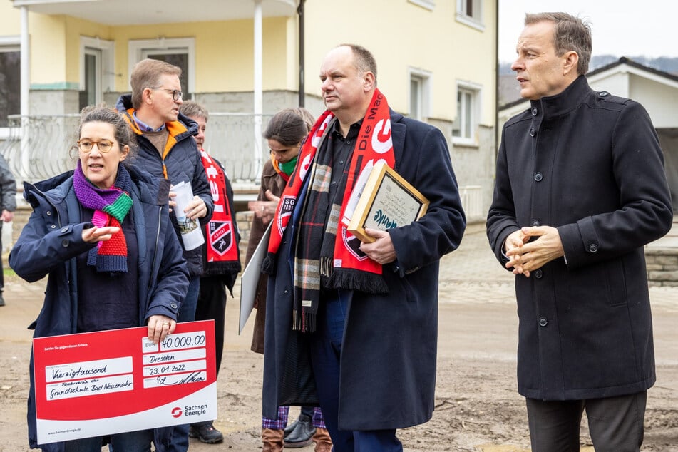 OB Dirk Hilbert (50, FDP, M.) und SachsenEnergie-Chef Frank Brinkmann (54) haben der Grundschul-Rektorin Ursula Bell einen Spendenscheck übergeben.