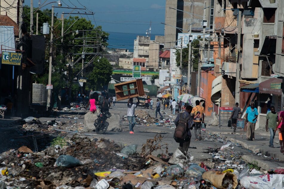 Thousands of Haitians were evacuated after gang members killed almost 200 voodoo practitioners in Port-au-Prince.