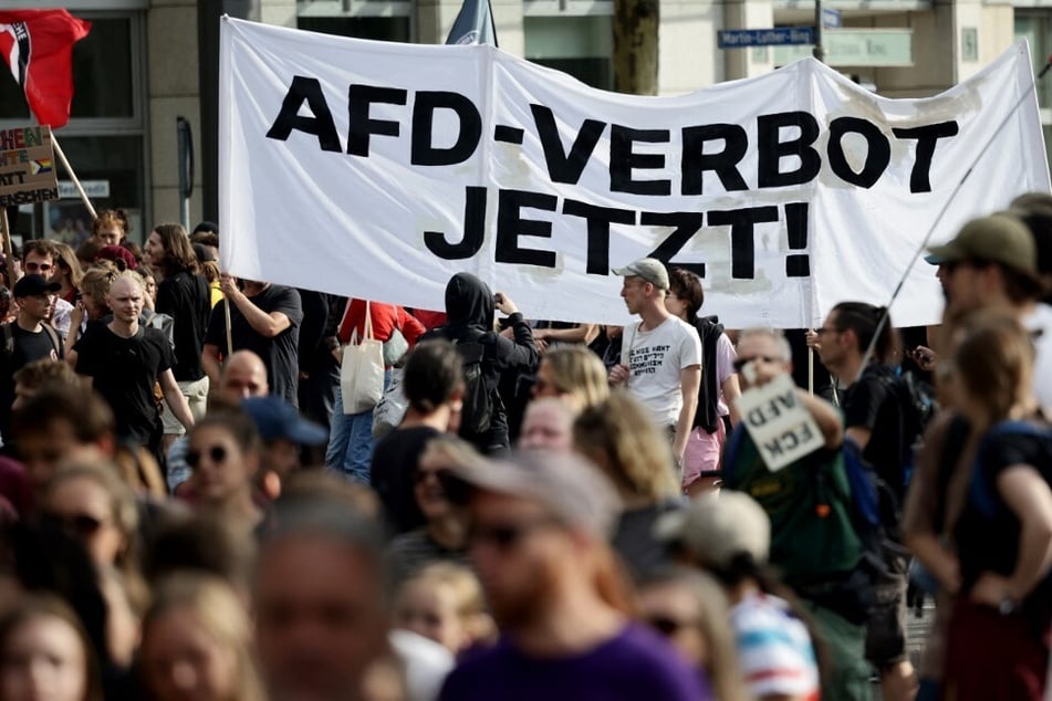 People carry a banner reading "AfD ban now" as they demonstrate against right-wing extremism in Leipzig, Germany.