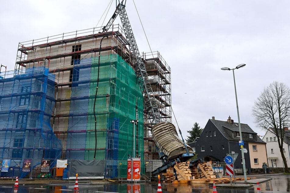 In Erkrath ist ein Baukran auf einen Rohbau gekippt.