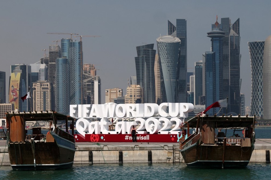 A FIFA World Cup sign is backdropped by the skyline of Doha ahead of the Qatar 2022 World Cup soccer tournament.