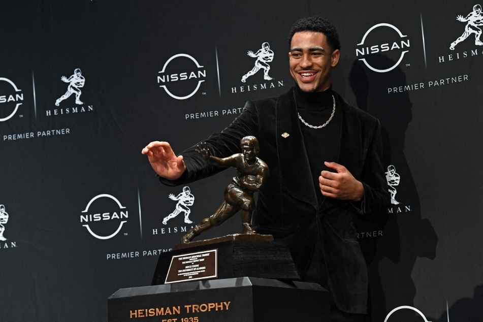 2021 Heisman Winner Bryce Young of Alabama hit the Heisman pose after winning last year's award for the best player in college football. Who will win this year?